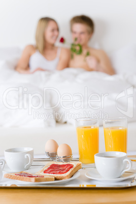 Luxury hotel honeymoon breakfast - couple in bed