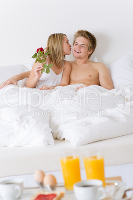 Luxury hotel honeymoon breakfast - couple in bed