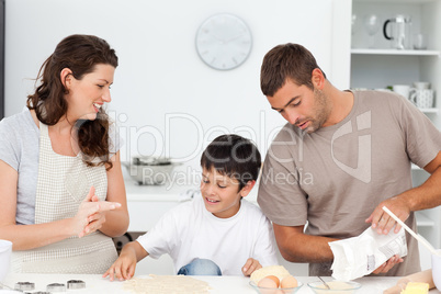 Caucasian family cooking biscuits together in the kitchen