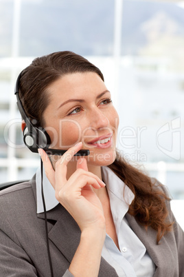 Pensive businesswoman talking on the phones using headphones
