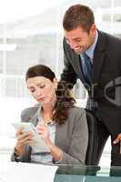 Concentrated woman taking notes whiletalking to her manager