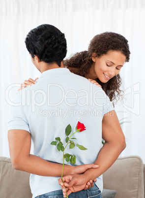Beautiful woman finding a rose hidden by his boyfriend