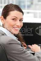 Rear view of a happy businesswoman working on her laptop