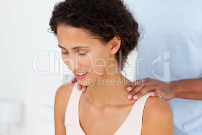 Close up of a woman enjoying a massage on her bed