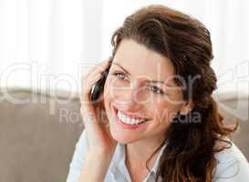 Pretty businesswoman talking on the phone at home