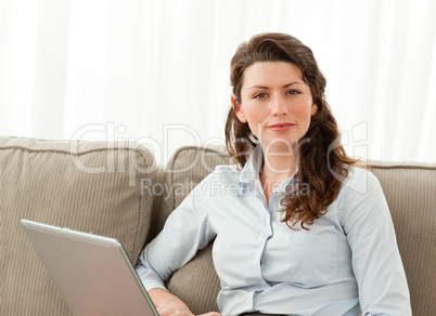 Charismatic businesswoman working in the living room