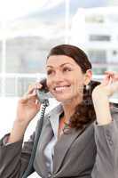 Joyful businesswoman talking on the phone