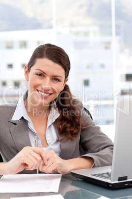 Pretty woman on the computer smiling at the camera