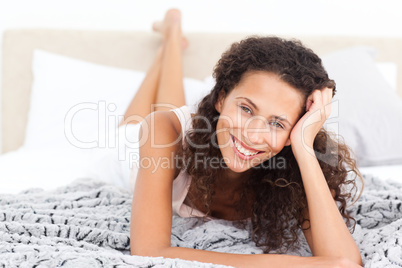 Beautiful woman lying on her bed