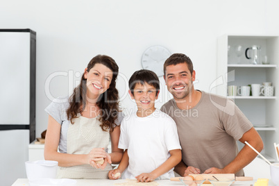 Portrait of a happy family preparing biscuits together