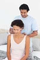 Attentive man doing a massage to his beautiful wife