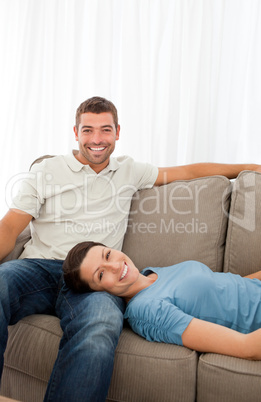 Portrait of a cheerful couple resting together on the sofa