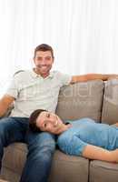 Portrait of a cheerful couple resting together on the sofa