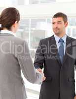 Businessman shaking hands with a businsswoman