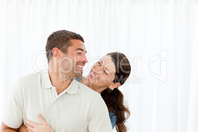 Lovely couple laughing together in the living room