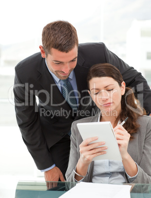 Handsome businessman speaking to a female colleague