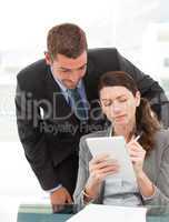 Handsome businessman speaking to a female colleague