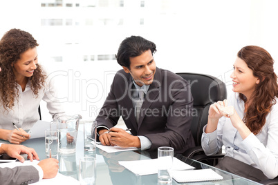 Businessman and businesswomen talking together around a table