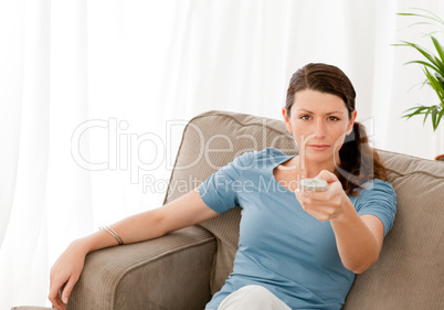 Charismatic woman watching television at home