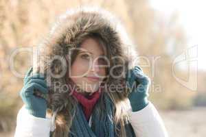 Winter fashion - woman with fur hood outside