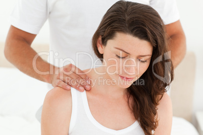 Pretty woman enjoying a back massage from her boyfriend