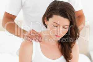 Pretty woman enjoying a back massage from her boyfriend