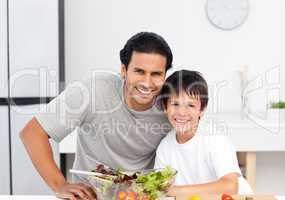 Portrait of a cute boy with his father in the kitchen