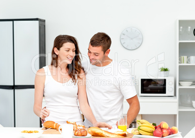 Lovely couple preparing their breakfast together