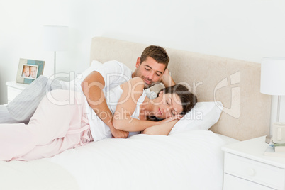 Attentive man looking at his girlfriend sleeping