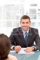 Happy businessman during an interview with a female colleague