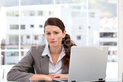 Businesswoman on the computer looking at the camera