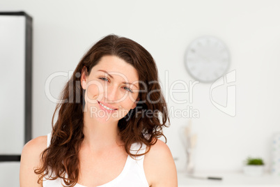 Portrait of a radiant woman in pyjama in her kitchen