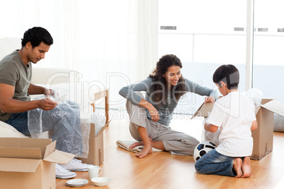 Happy family packing dishes together in their living-room