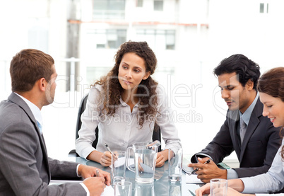 Beautiful manager speaking with her team during a meeting