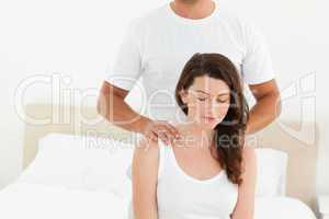 Attentive man doing a back massage to his beautiful wife
