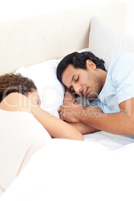 Cute couple sleeping together in their bed during a weekend