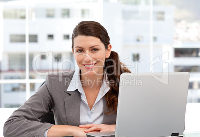 Smiling woman on the computer looking at the camera