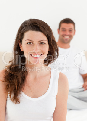 Adorable woman sitting on her bed with her boyfriend
