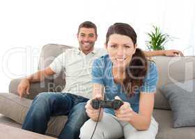 Concentrated woman playing video game with her boyfriend