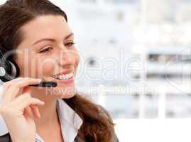 Smiling businesswoman talking on the phone with headphones