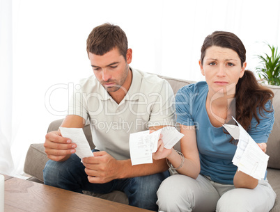 Desperate woman doing her accounts with her boyfriend sitting on