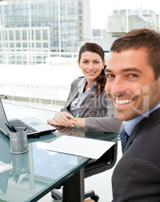 Two positive business people smiling at the camera
