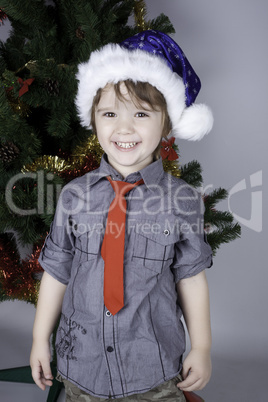 Child posing near a Christmas tree Child posing near a Christmas tree