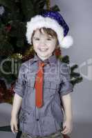 Child posing near a Christmas tree