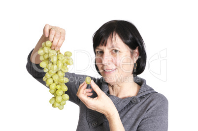 Retired woman eating grapes Retired woman eating grapes