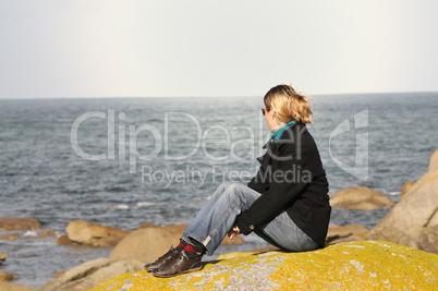 Young woman watching the ocean
