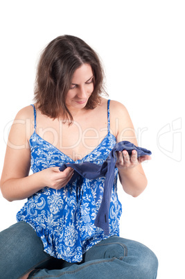 Portrait of pretty pregnant woman baby clothes