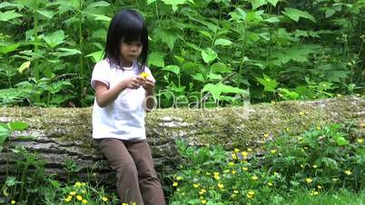 Little Asian Girl Picking Yellow Flowers