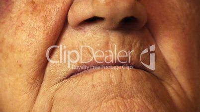 Senior old woman mouth wrinkle skin close up