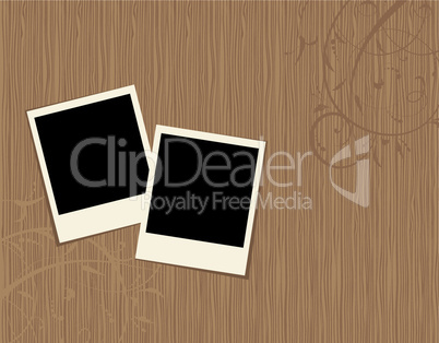 Two photo frames on wooden background